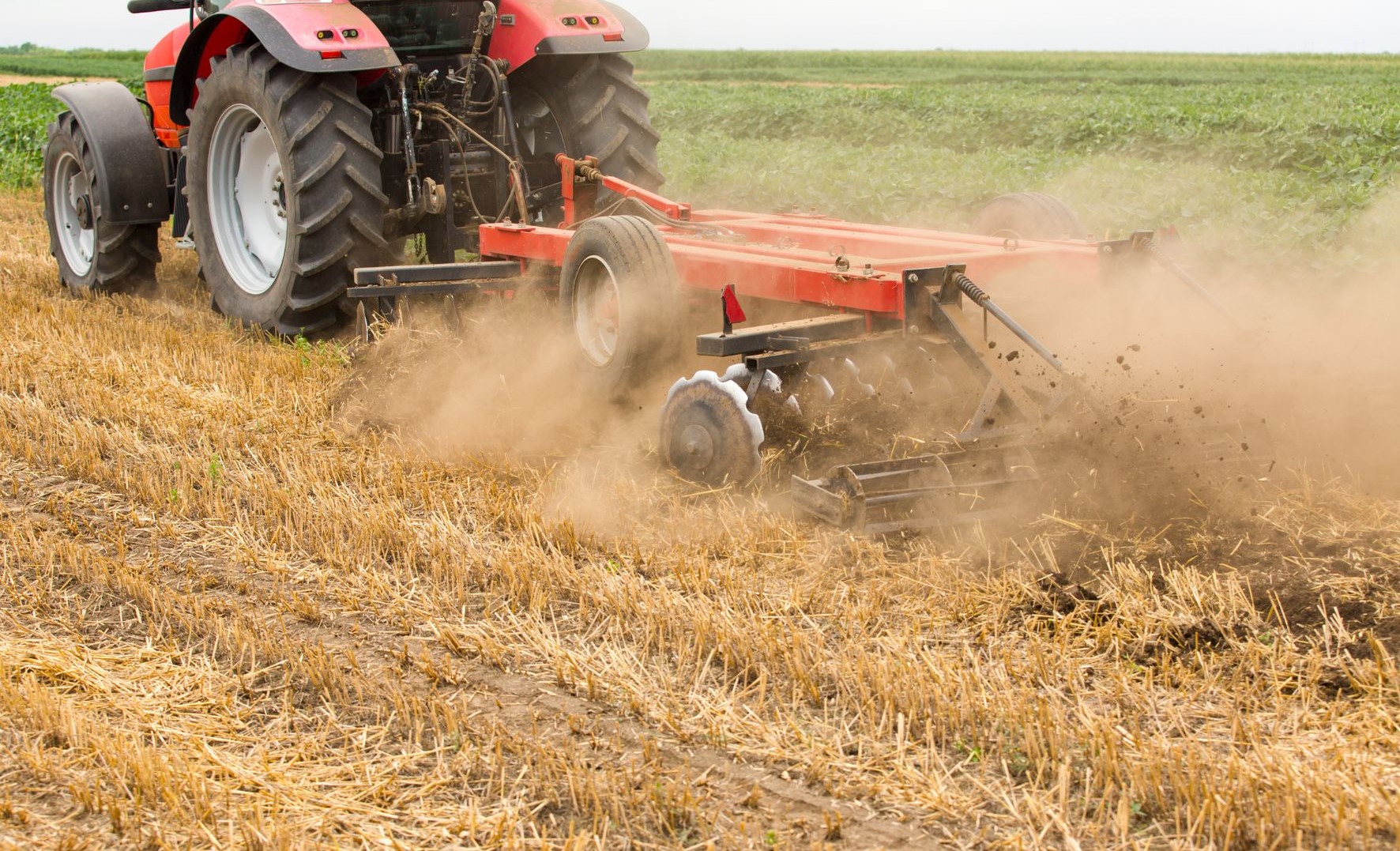 Mechanized tractor disc tilling and managing post-harvest crop residue in the field